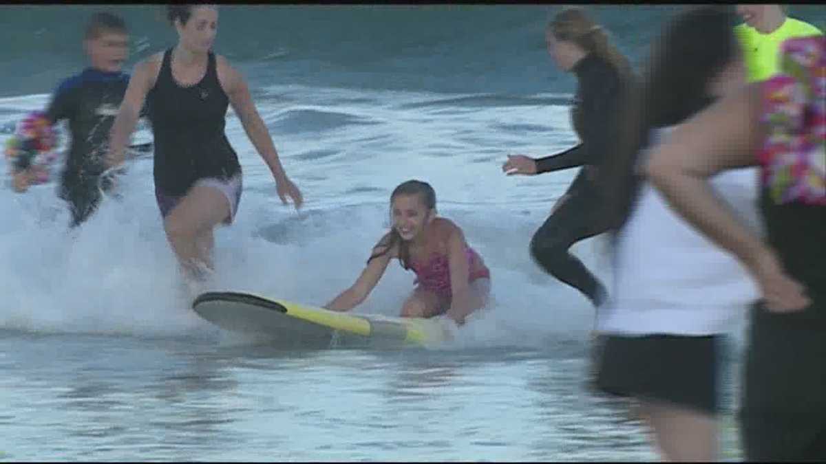 Surfing With Smiles offers free surfing lessons to special needs children