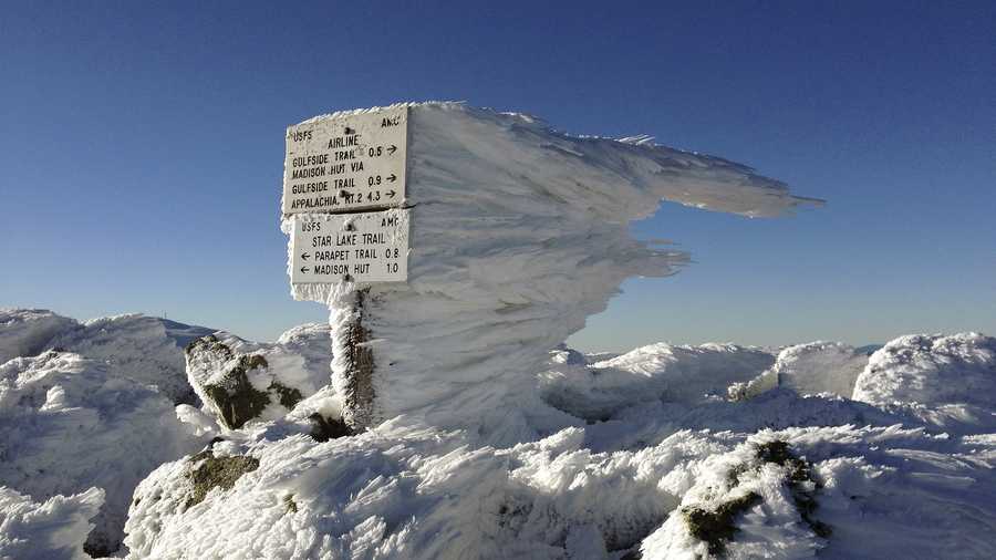 Rime ice extends several feet horizontally from a sign marking the summit of 5,774-foot Mount Adams, the second highest mountain in New England, on Tuesday, Nov. 17, 2015, in northern New Hampshire. Monday's freezing fog and strong winds formed the rime ice, creating a winter wonderland above treeline in New Hampshire's aptly named White Mountains.