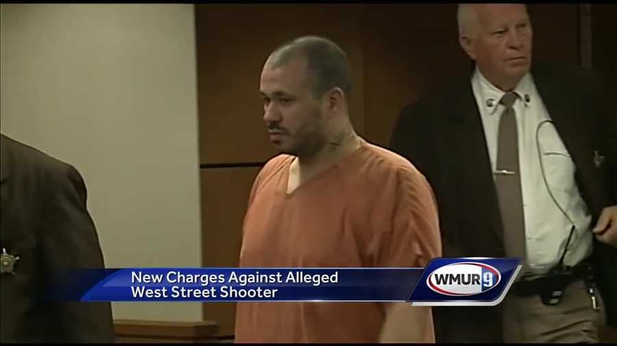 A man accused of firing shots into a Manchester apartment building was back in court Monday to face new charges.