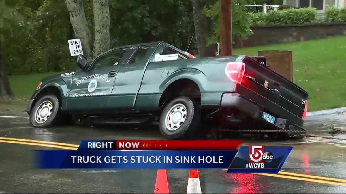 Truck gets stuck in sink hole responding to water main