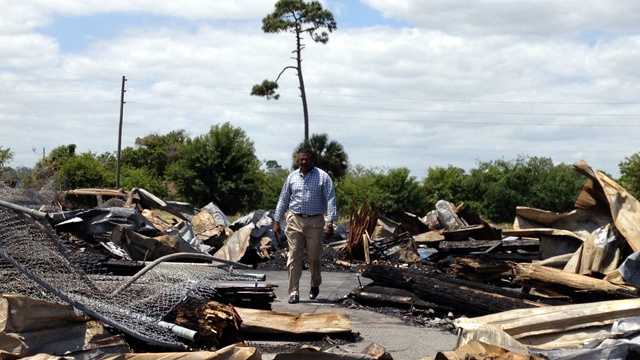 Pastor Jerome Rhyant at Love Center Ministries surveys the damage from the fire that destroyed the thrift store. (Cathleen O'Toole/WPBF)