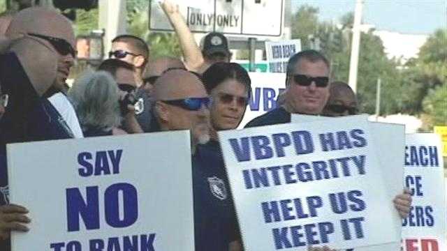 Dozens of Vero Beach police officers protest a plan that would eliminate positions and demote some top officials.