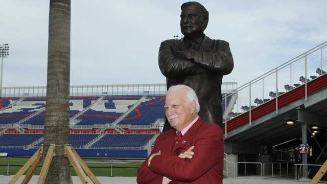 Howard Schnellenberger stands in front of a statue of himself on the southwest side of FAU's new 30,000-seat, on-campus football stadium. Schnellenberger led Miami to its first national title in 1983 and later helped start FAU's football team. (Florida Atlantic University)
