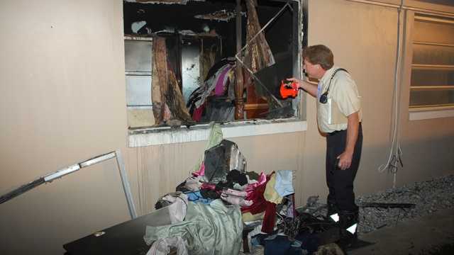 Fire inspector Gary Keidel inspects the damage to an apartment on West Camino Real. (Frank Corregio/Boca Raton Fire Rescue)