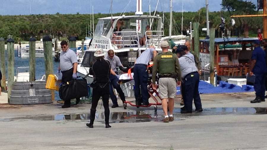 A scuba diver is placed on a stretcher after being brought to the Riviera Beach marina.
