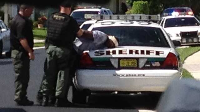 Deputies take a bank robbery suspect into custody.