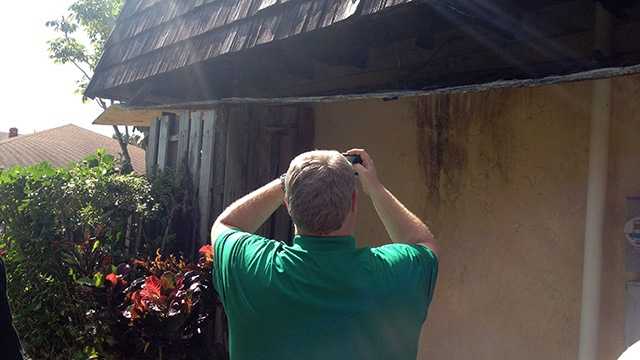 Chris Burnett surveys the damage at Rosemary Woodstock's home in West Palm Beach. His restoration company is going to fix it up for free. (Photo: Cathleen O'Toole/WPBF)