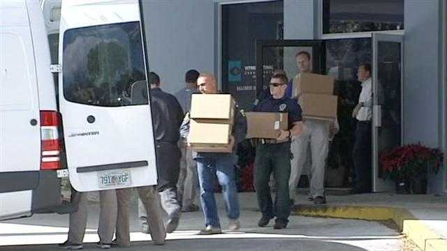 Federal agents remove boxes from Dr. Salomon Melgen's West Palm Beach office.