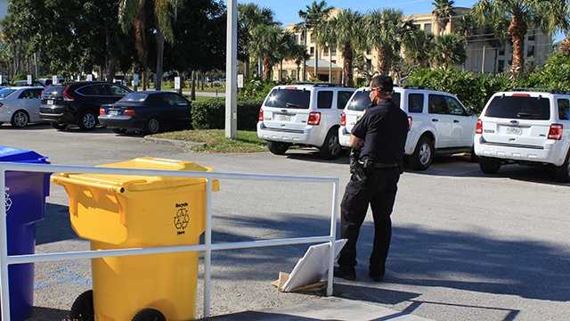A police officer guards the suspicious package that was delivered to the WPBF 25 News studios on Monday.