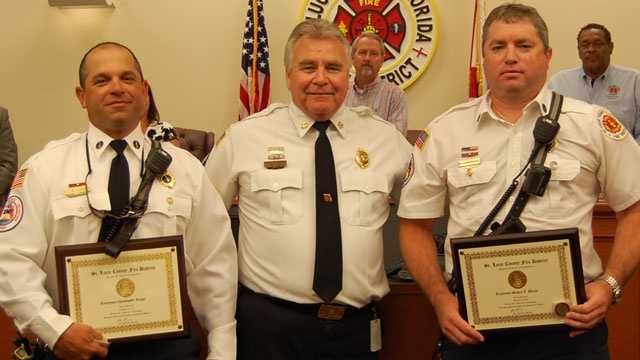 Lt. Christopher Longo (left) and Lt. Steven Burns (right) were recently honored after saving a boy from a burning home. St. Lucie County Fire District Chief Ron Parrish (center) presented the firefighters with the Chief's Award of Excellence.