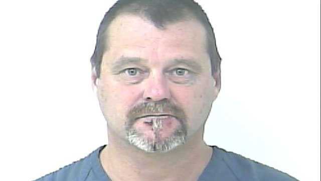 Dean Bair is accused of pulling a gun and yelling racial slurs at the driver who cut him off.