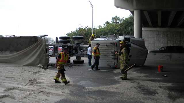 This truck overturned, spilling sand onto Atlantic Avenue in Delray Beach.