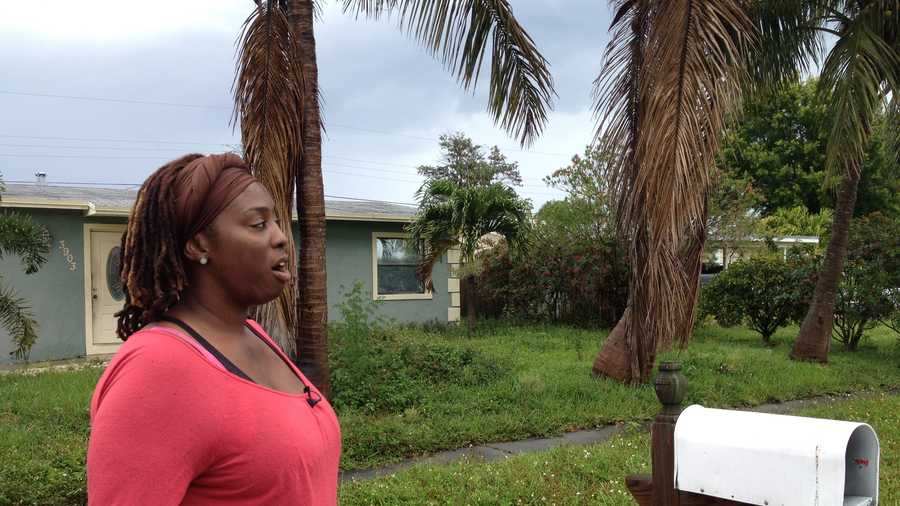 Naomie Breton, who was set on fire by her ex-fiancé last year, stands outside the Lantana home that squatters have taken over, but authorities can't do anything about it.