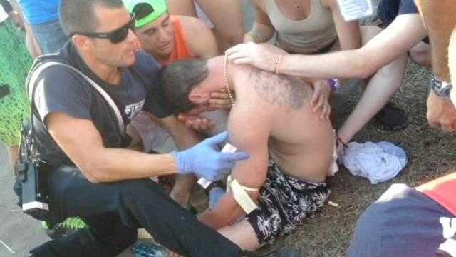 Paramedics treat a man after a brawl on the final day of SunFest in West Palm Beach.