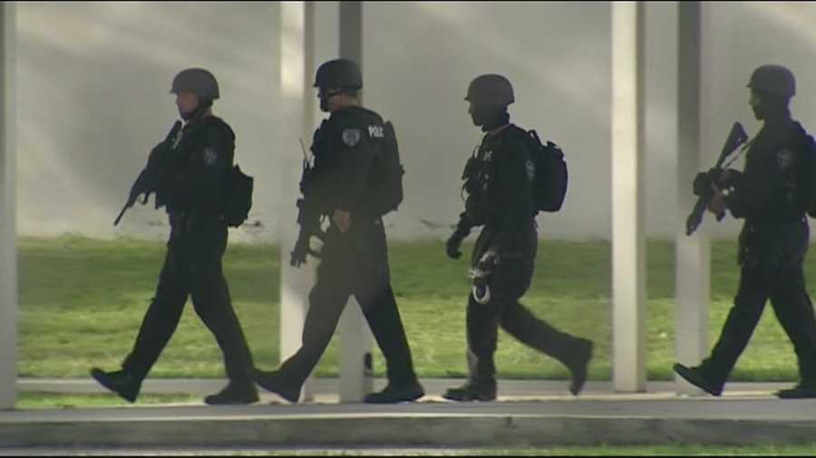The SWAT team inspects every building at the Dreyfoos School of the Arts after 2 people were found dead on campus.