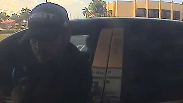 Police say this surveillance image from an ATM shows one of the gunmen making a cash withdraw.