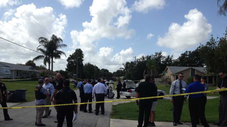 Police gather at the scene in Port St. Lucie where a shootout took place after one of three bank robberies.