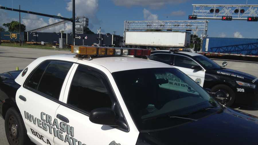 A CSX train blocks the intersection of Dixie Highway and Glades Road in Boca Raton after a fatal crash.
