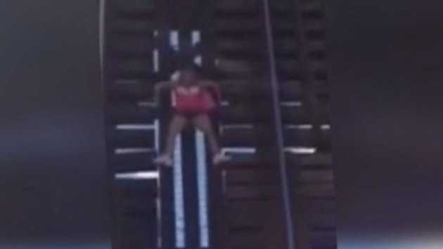 A woman was dangling from a Fort Lauderdale railroad bridge until firefighters rescued her.