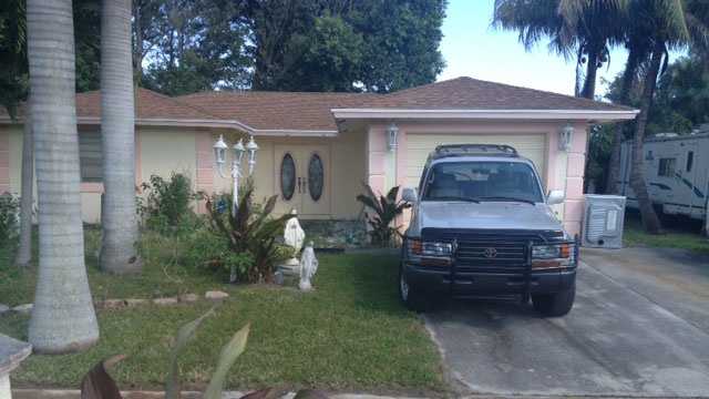 A woman was wounded by a stray bullet at this home on Lilac Circle in Lake Worth.