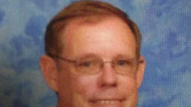 Science teacher Greg Sims has been suspended without pay for taping a disruptive student's hands together, school officials say.