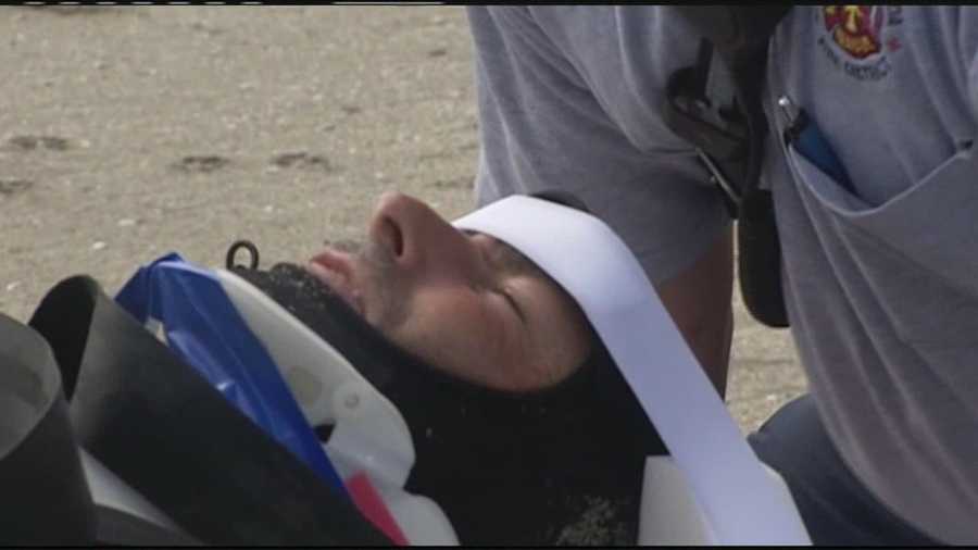 A surfer injures his neck during the rough surf in Fort Pierce and leaves the beach on a stretcher.
