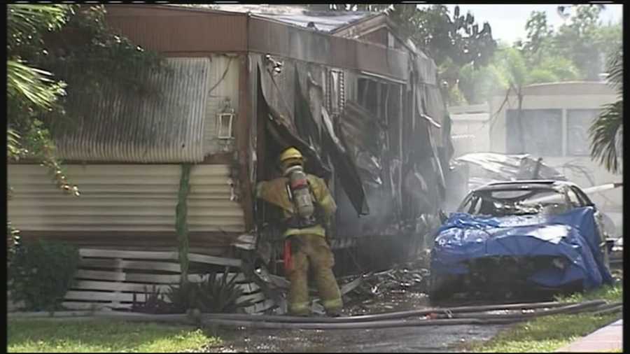 Firefighters battled more than just flames after a fire spread from one mobile home to another Friday in Greenacres.
