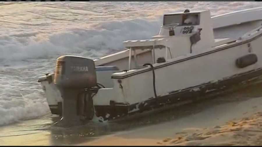 Six migrants were taken into custody after they came ashore in this boat on Palm Beach.