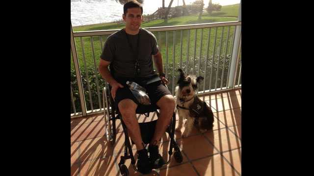 Derek Herrera poses with his service dog, Shaggy.