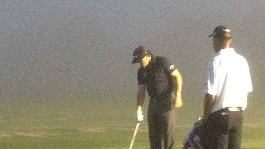 Phil Mickelson battles the fog at the practice range at PGA National early Wednesday morning.