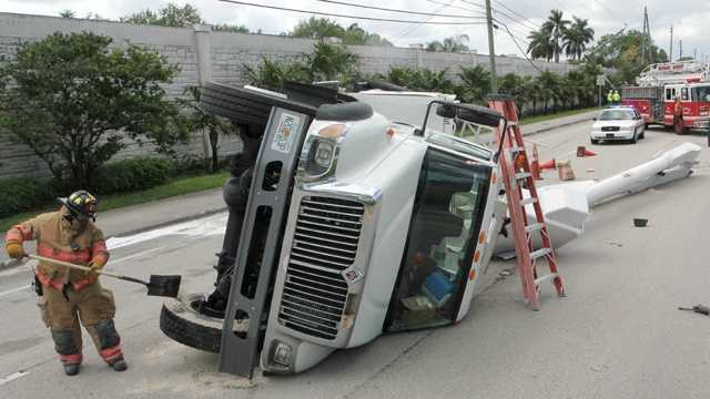 This utility truck traveling with its bucket raised struck a traffic signal in Cooper City, knocking the truck on its side. (Mike Jachles/Broward Sheriff's Office)