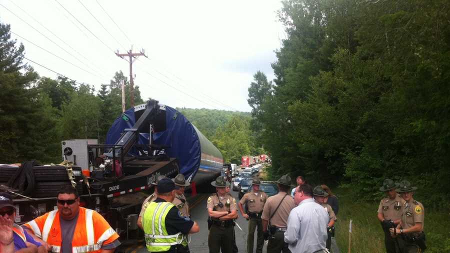 A spokeswoman for a Vermont utility says protesters have stopped traffic on Route 100 while officials try to deliver components to be used as part of the Lowell Mountain wind project.