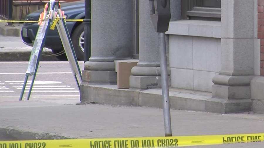 Police inspect a suspicious package left on a windowsill at the T.D. Bank in Montpelier.