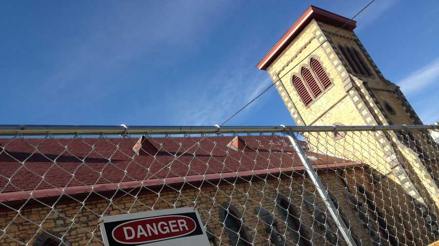 Its steeple now removed, chain link fencing now surrounds part of the College St. Congregational Church in Burlington.