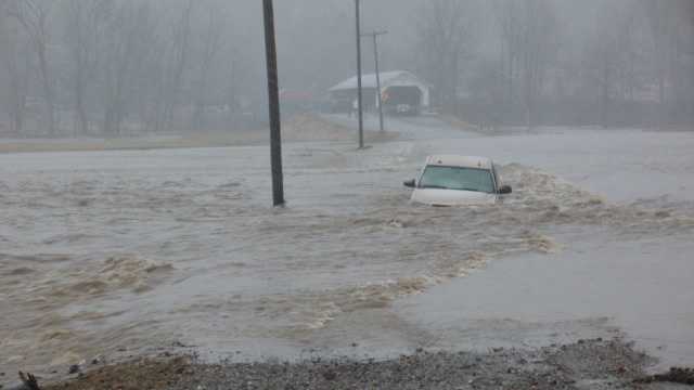 A Franklin County Sheriff's corporal and two other men rescued a woman from rising floodwaters Tuesday afternoon, Vermont State Police said.