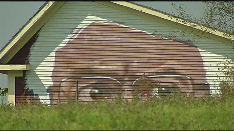 The mural shows a close-up view of Bernie Sanders, featuring his glasses and expressive eyes.