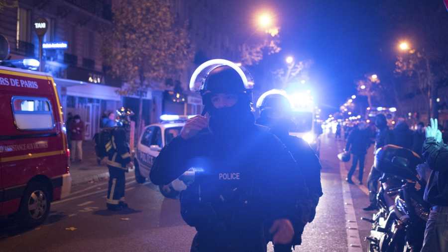 Elite police officers arrive outside the Bataclan theater in Paris, France, Wednesday, Nov. 13, 2015.