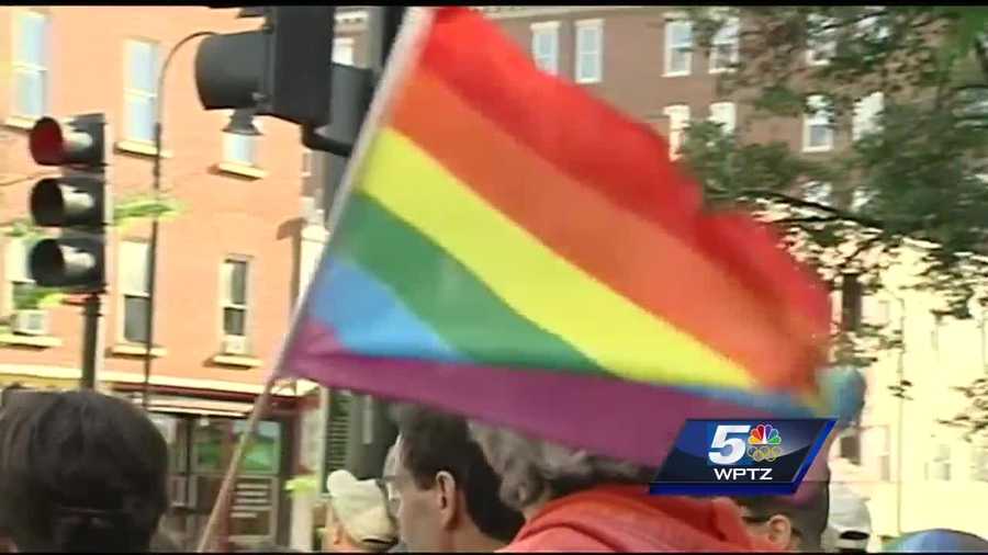 An estimated 2,000 people marched down Church Street to the steps of City Hall Monday evening wearing rainbow colors, carrying signs, singing for strength.