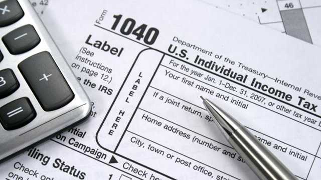 tax forms with pen, calculator, taxes