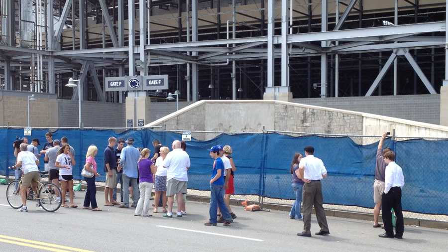 A crowd gathered around the spot where a statue of Joe Paterno stood for years outside Beaver Stadium on the Penn State University campus.