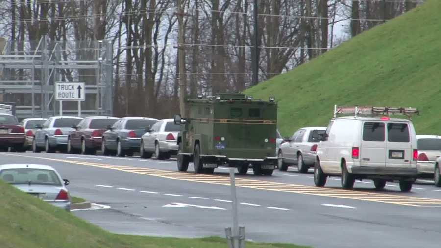 Photos Police surround stolen rifle suspect in field