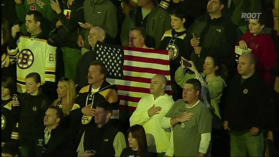 A fan holds up a Boston Strong tee shirt during a moment of