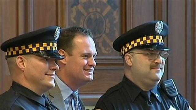 Mayor Luke Ravenstahl poses for a picture with two Pittsburgh police officers