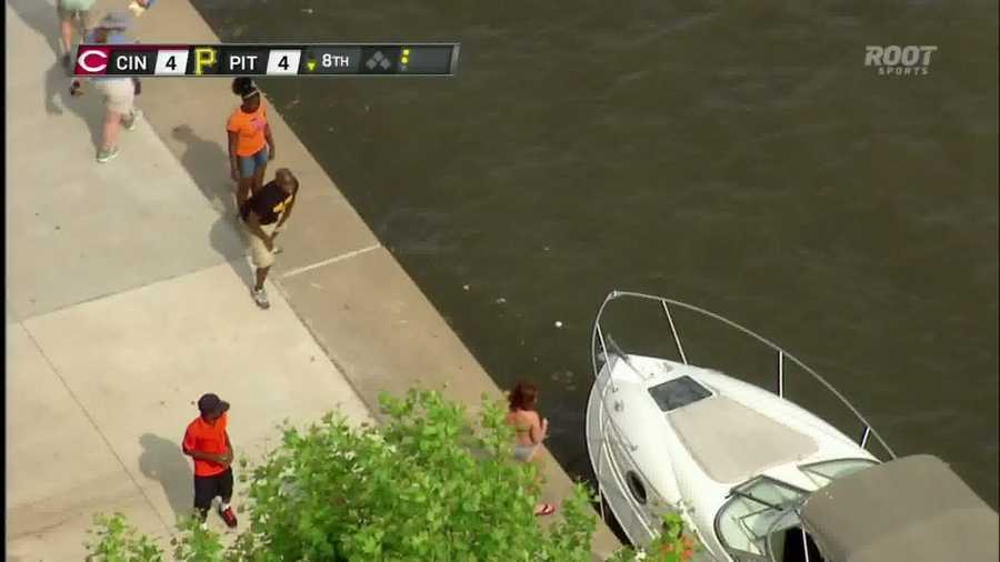 Fans watch the baseball splash into the Allegheny River after a home run by Garrett Jones.