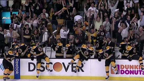 The Boston Bruins and their fans celebrate after a double-overtime victory in Game 3 of the Eastern Conference finals against the Penguins.