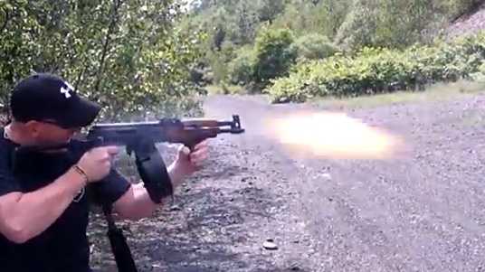 Mark Kessler fires an automatic weapon.