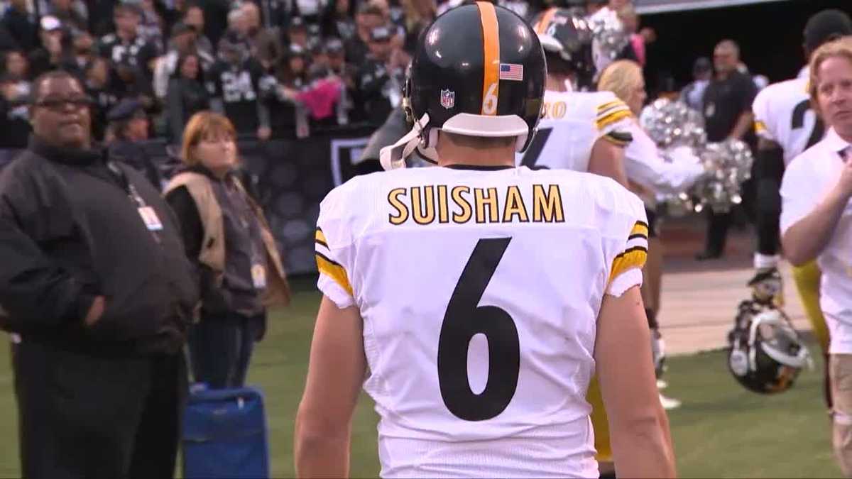 New Dallas Cowboys kicker Shaun Suisham carries his gear off the