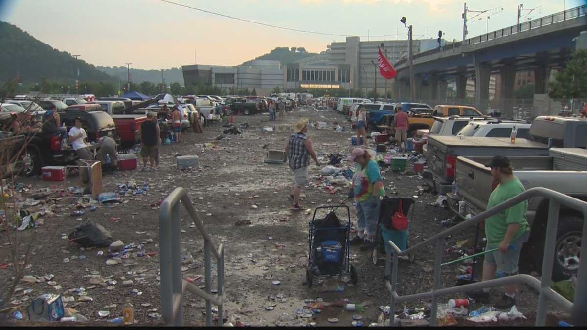 City crews clean trash left behind by tailgaters in the Muni Lot