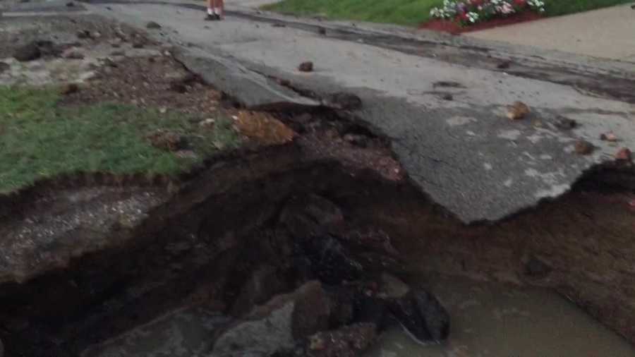 PHOTOS: Water shoots into the air, sinkhole blocks road