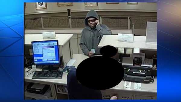 Who's he talking to? Downtown bank robber keeps phone to head whole time
